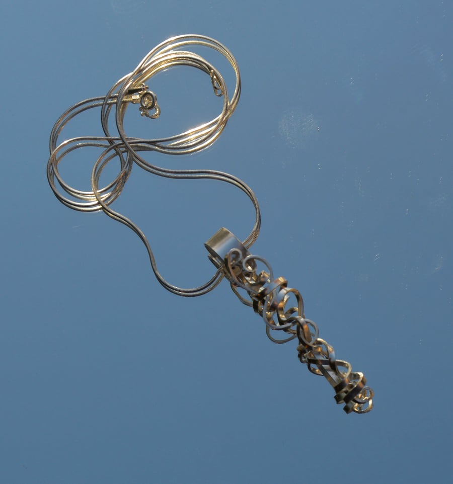 Sterling silver curly pendant.
