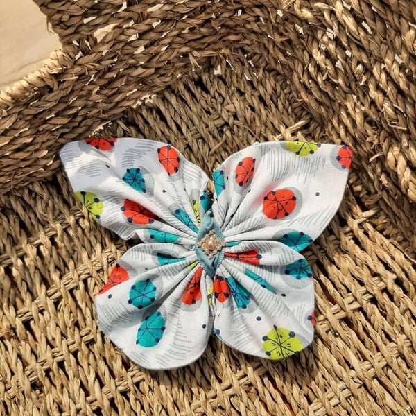 BUTTERFLY COLOURFUL FABRIC HAIR CLIP WITH BLUE RIBBON AND PEARL CENTRE