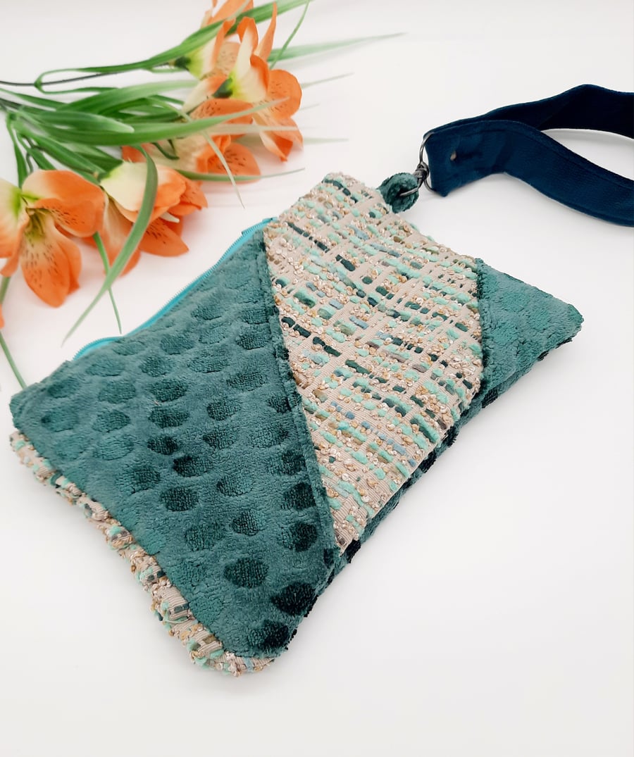 Teal clutch bag with teal velvet handle.