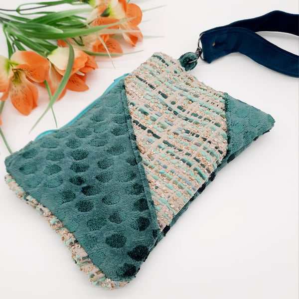 Teal clutch bag with teal velvet handle.