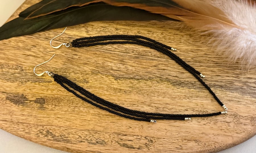Long black gothic beaded fringe earrings with silver tips