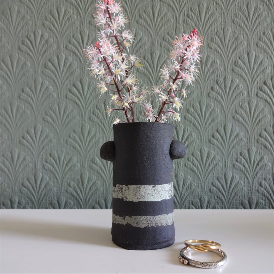Tiny bud vase, place setting, matt black ceramic, abstract banded decoration. 