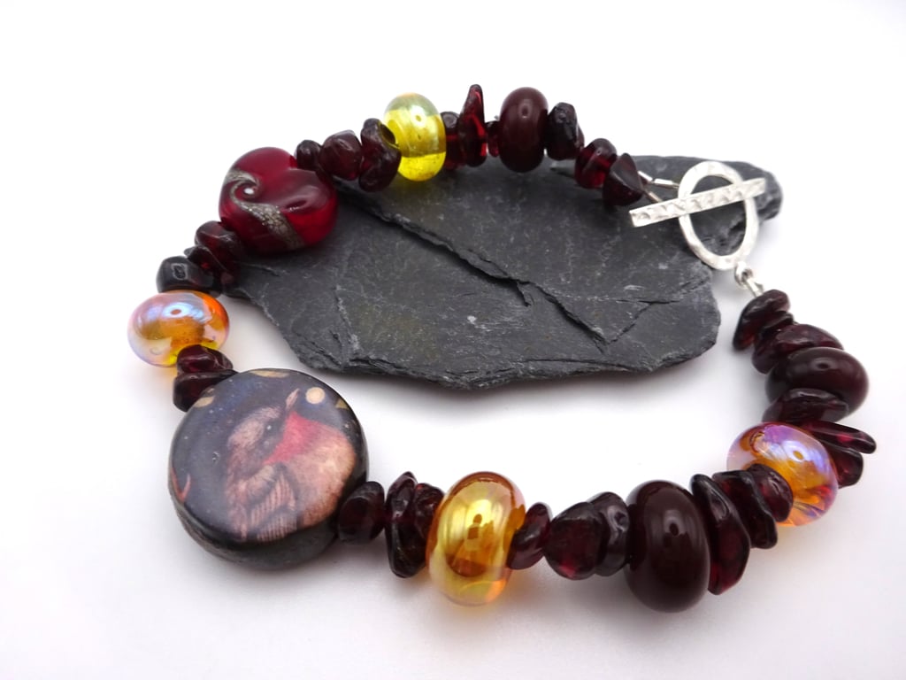 ceramic robin, gold lampwork glass and garnet gemstone bracelet