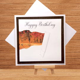 Striking autumnal torn paper aperture birthday card