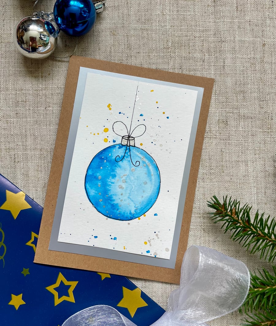 Christmas card, hand painted original of a single christmas bauble in pale blue.