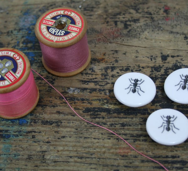 A set of three bone china buttons with ant image