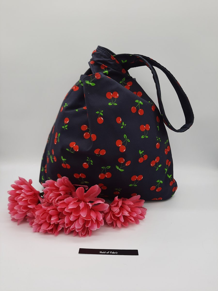 Knot bag,  medium shoulder bag, reversible in blue denim and cherry. 