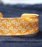 Geometric seed head print cuff bracelet orange