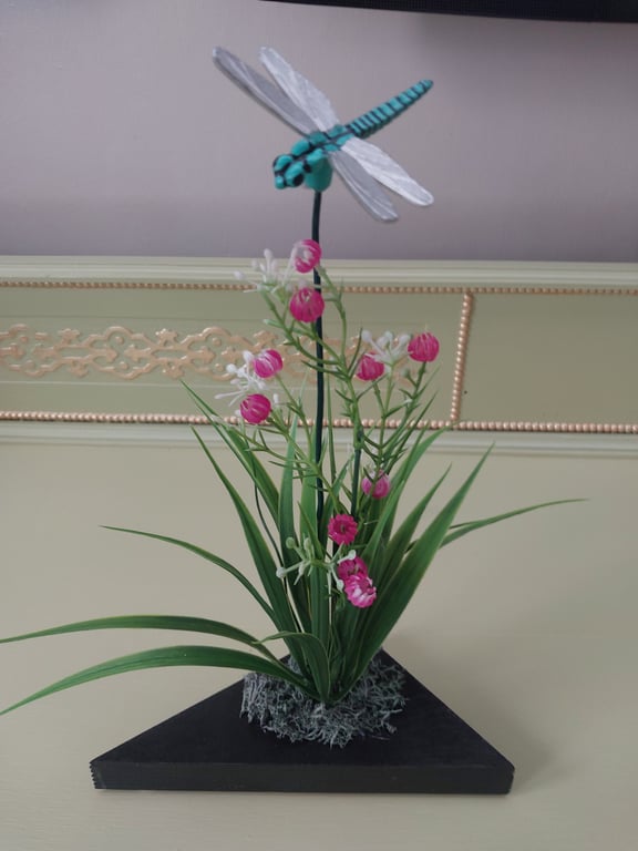 Dragonfly flower display on wooden plinth
