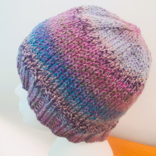 Hand knitted adult beanie hat in purple and blue colour changing yarn