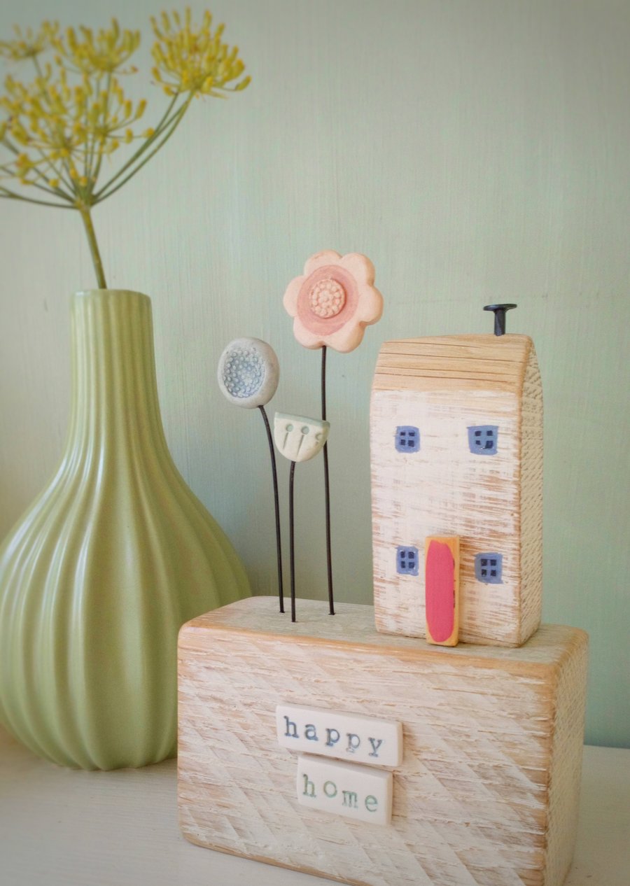 Wooden house with clay flower garden 'happy home'