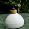 White hand -thrown stoneware soap dispenser with pump.