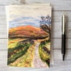 Country lane with moorland printed greetings card.  