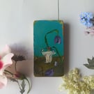 Miniature flower painting on reclaimed wood