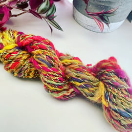 Hand spun art yarn. Cotton, Corriedale, wool locks, sparkle and merino.