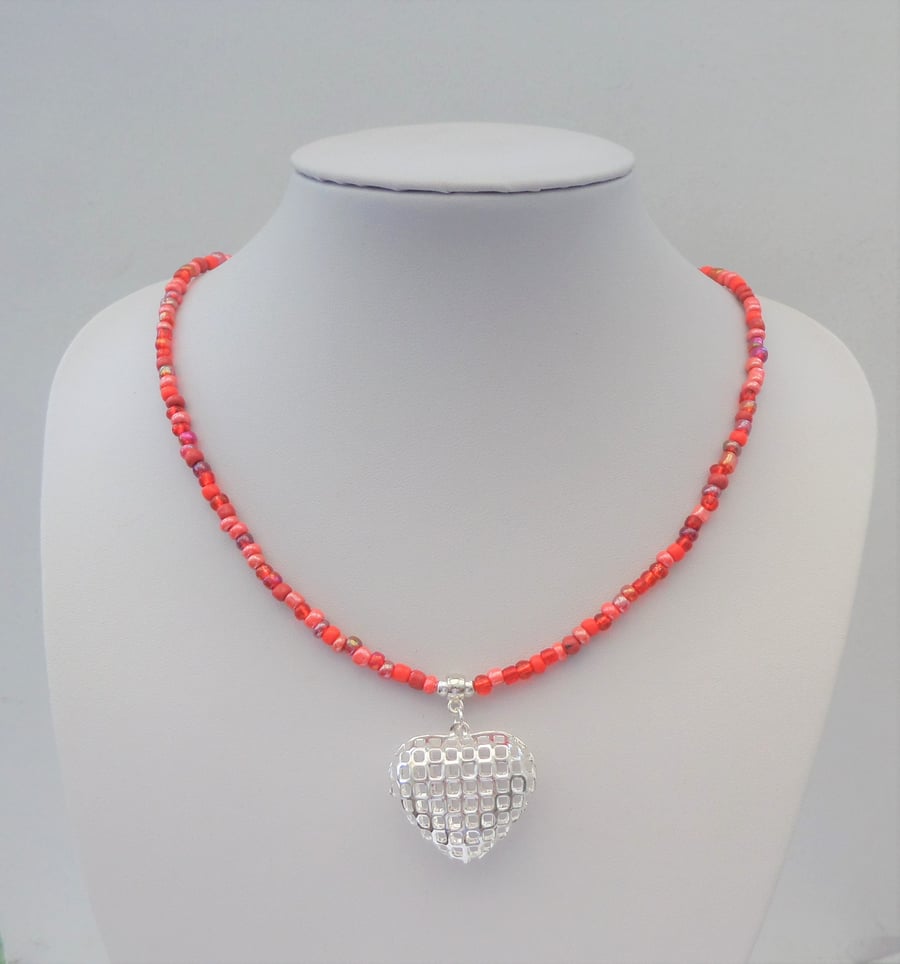 Red seed bead mix necklace with a silver coloured heart pendant