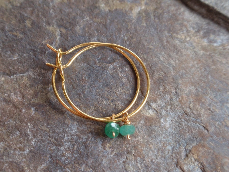 Gold plated hoop earrings with green emerald gemstones