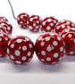 Handmade red and white patterned lamp work glass beads - Image 1