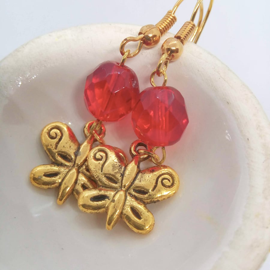 Earrings With a Red Crystal Bead and a Gold Plated Butterfly Charm