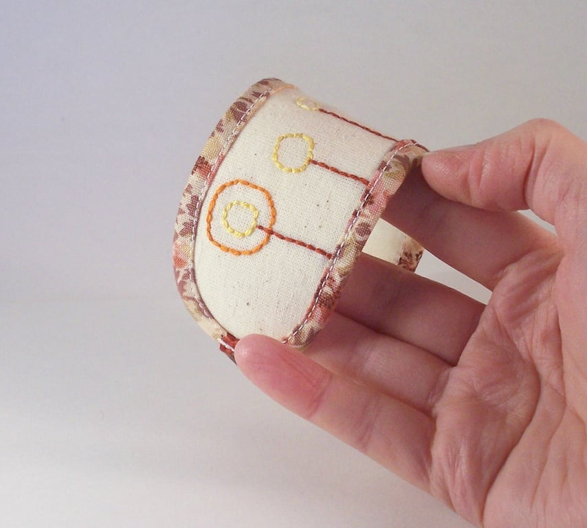 Hand embroidered fabric cuff in natural colours