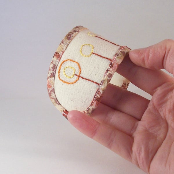 Hand embroidered fabric cuff in natural colours