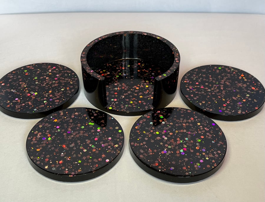 Set of 4 black with rose gold glitter coasters and holder.