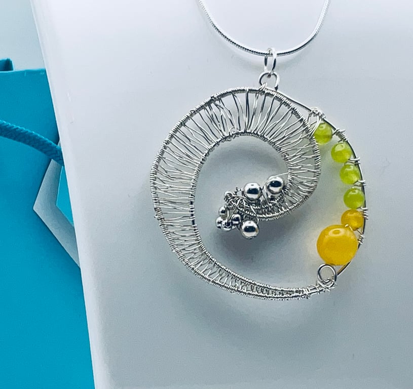 A breaking wave with yellow sand pendant