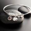 Sterling Silver Bangle with Heart Charms and Garnet