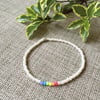 Rainbow and ivory elastic beaded bracelet, with silver star