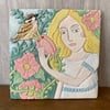 Hand carved ceramic tile with flowers and bird