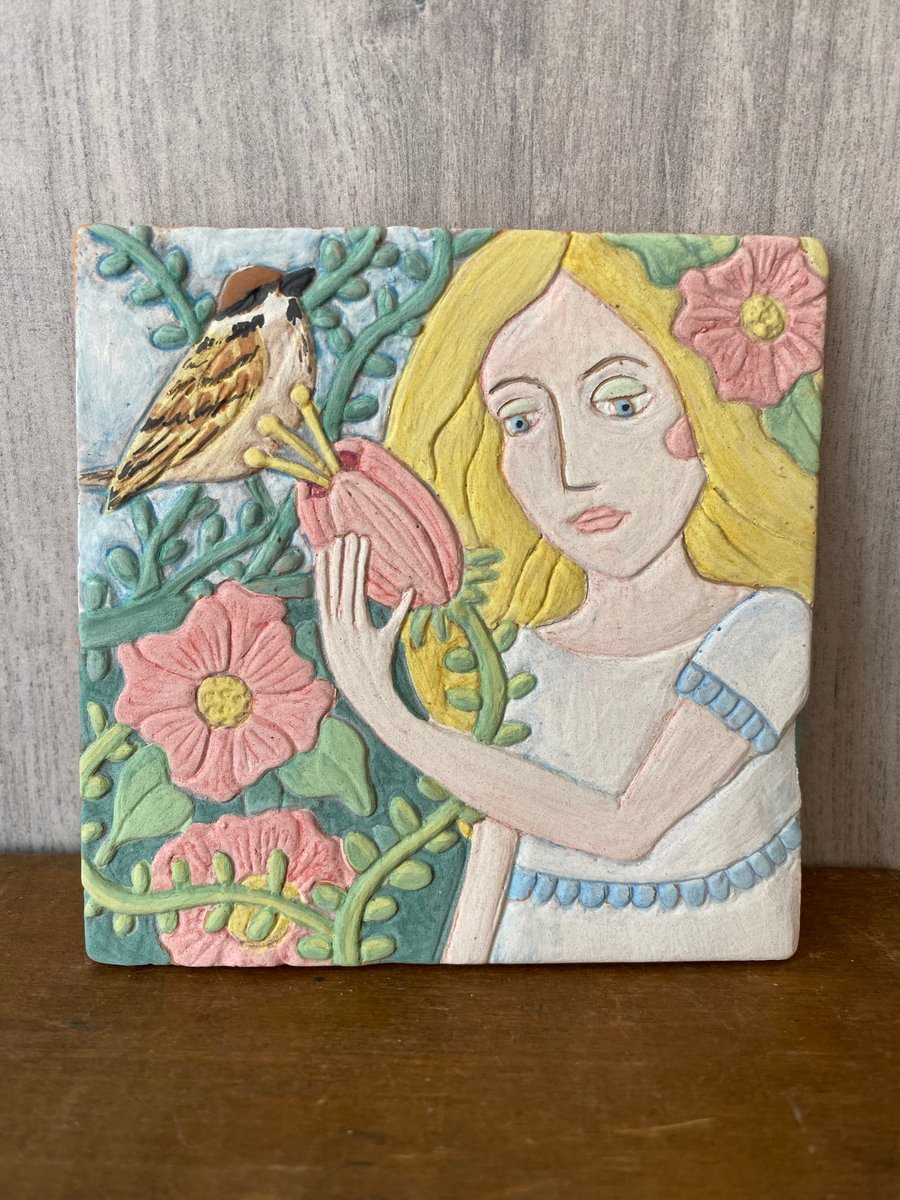 Hand carved ceramic tile with flowers and bird