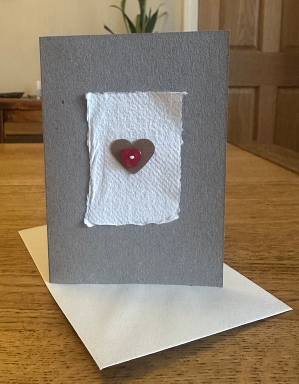 Greetings card with heart motif & red heart shaped button 