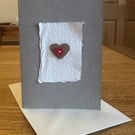 Greetings card with heart motif & red heart shaped button 