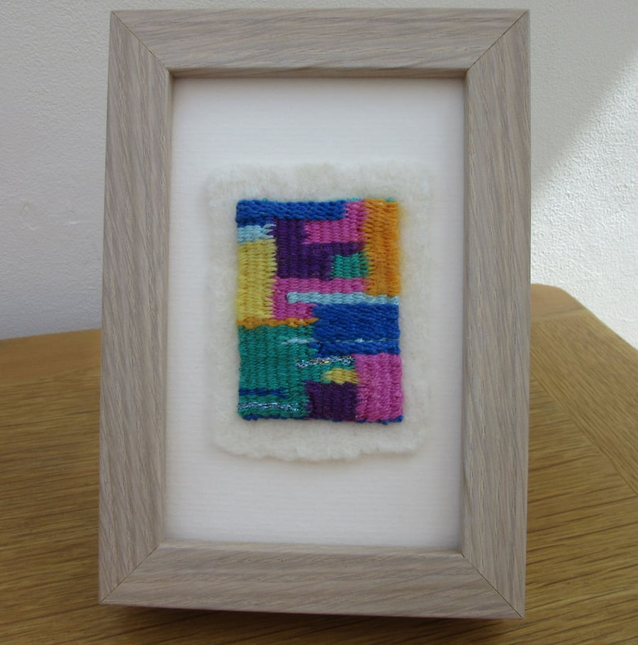Abstract weaving picture.  Contemporary brightly coloured framed woven textile