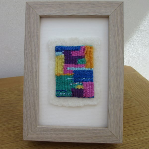 Abstract weaving picture.  Contemporary brightly coloured framed woven textile