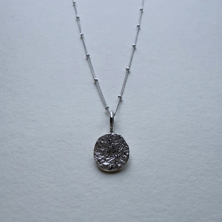 Reticulated Silver Coin Pendant