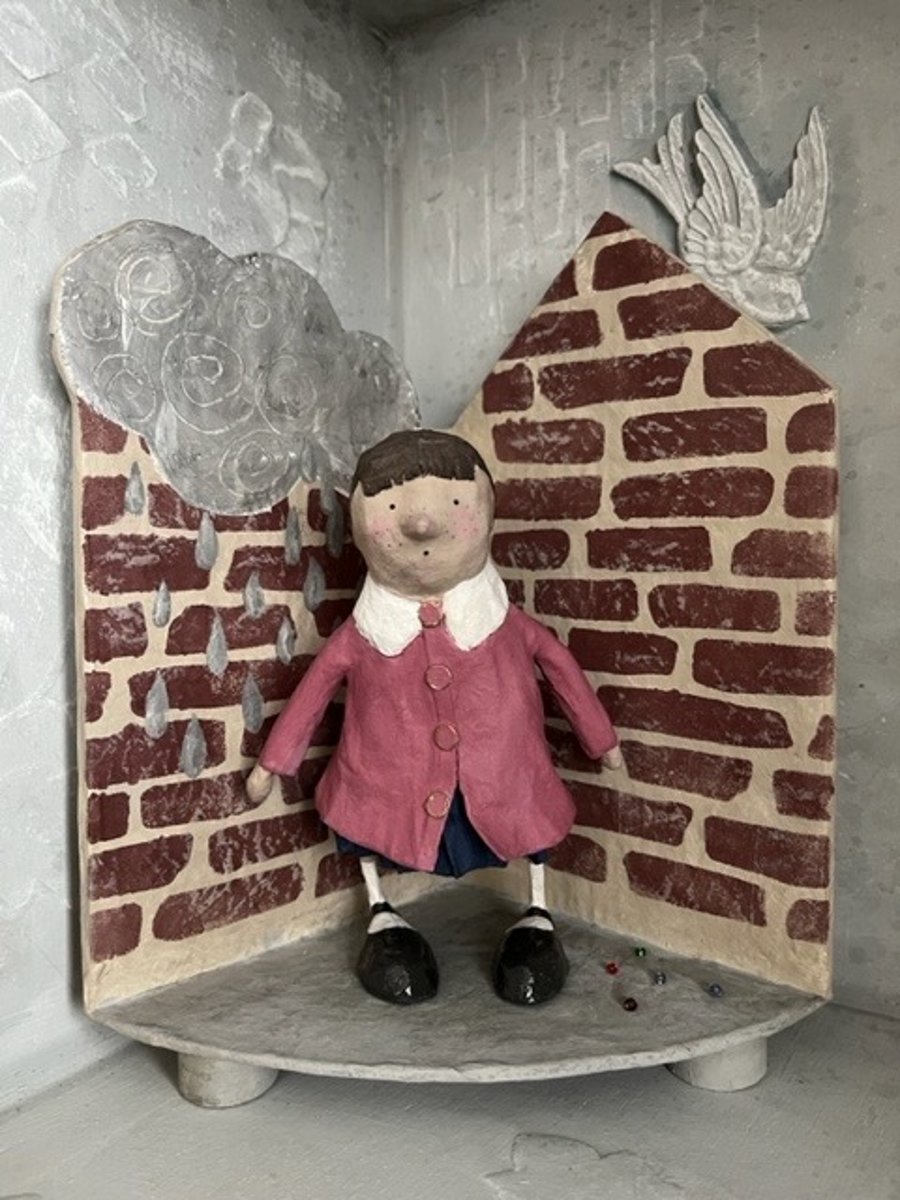 Paper mache artist doll on a platform