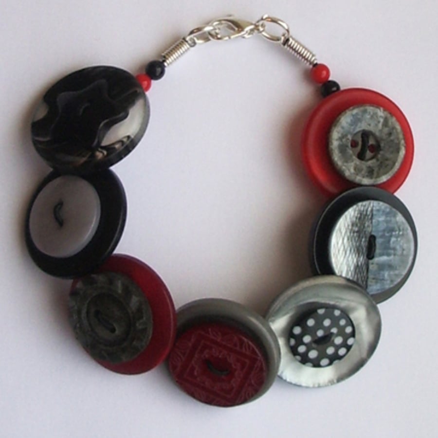 Red, black, grey/gray, silvery button bracelet