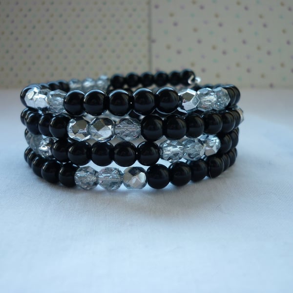 BLACK, SILVER AND CRYSTAL MEMORY WIRE BRACLET.  961