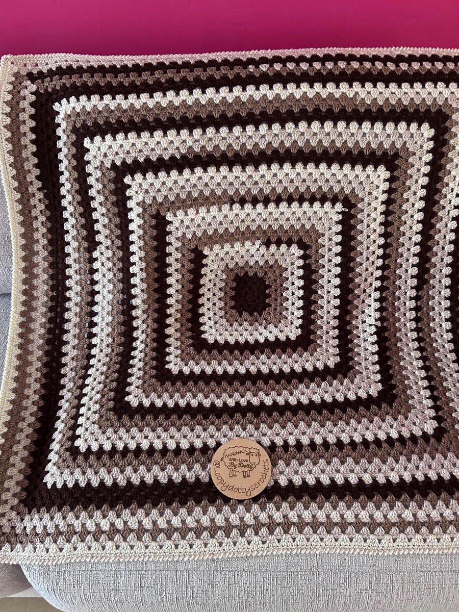 A handmade granny square crochet throw blanket