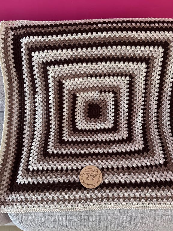A handmade granny square crochet throw blanket