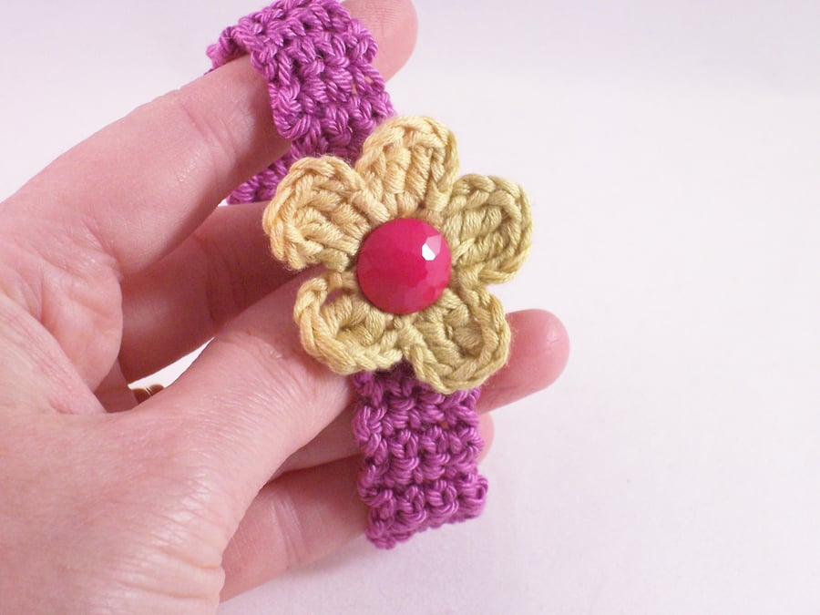 Blossom cuff - crochet in magenta with yellow flower blossom