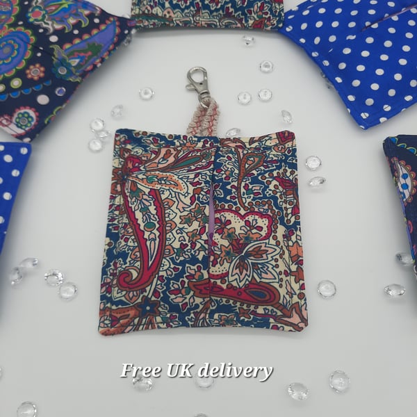 Bag charm sanitary towel holder in teal and raspberry pink pattern. 