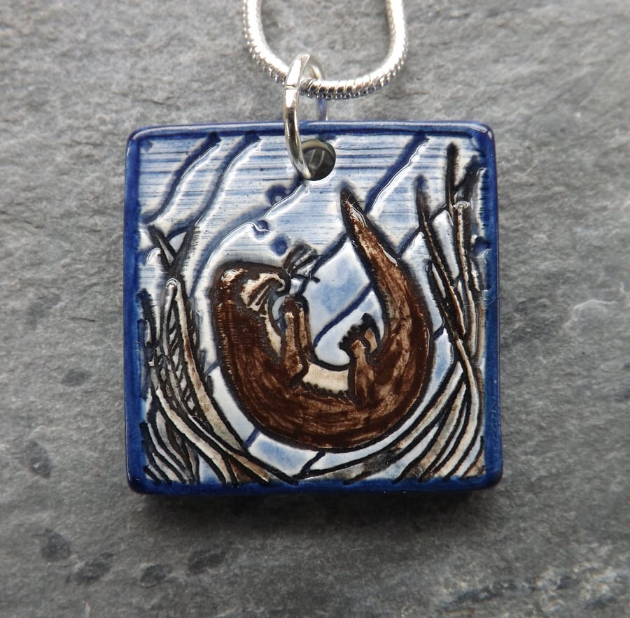 Handmade Ceramic Playful Otter Pendant in blue