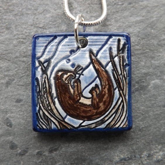 Handmade Ceramic Playful Otter Pendant in blue