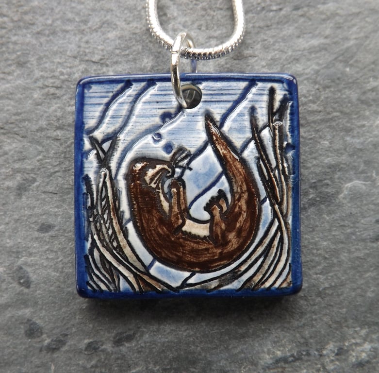 Handmade Ceramic Playful Otter Pendant in blue