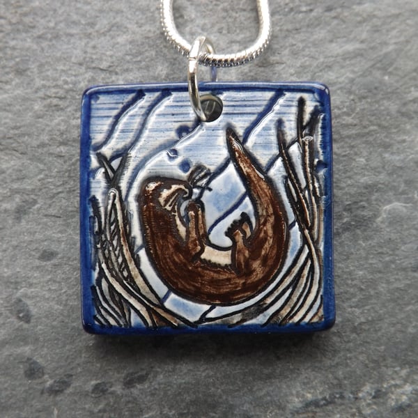 Handmade Ceramic Playful Otter Pendant in blue