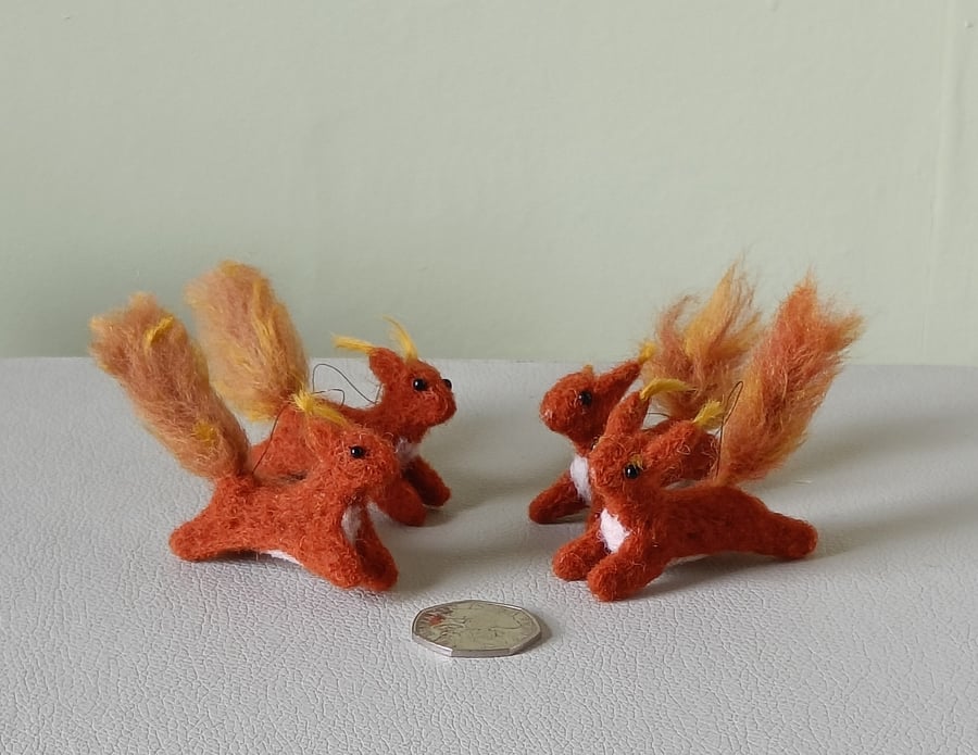 Wee red squirrels leaping -ginger