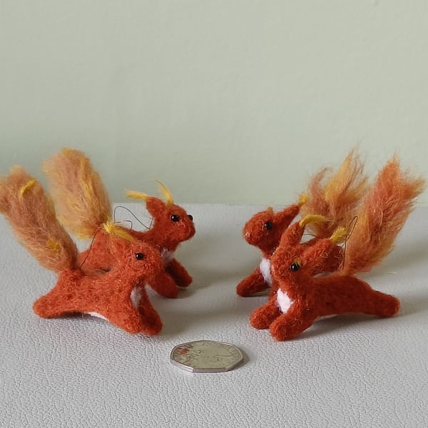 Wee red squirrels leaping -ginger