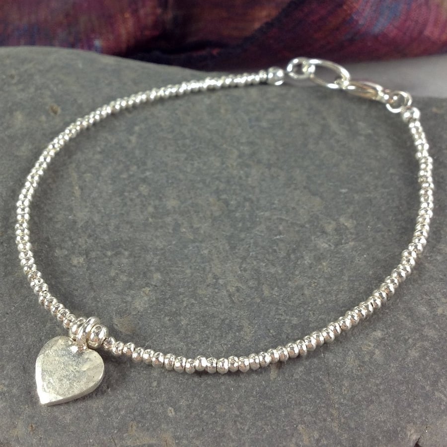 Silver friendship bracelet with heart charm
